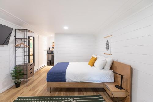 a bedroom with a bed with white walls at Bonnie View Inn in Haliburton