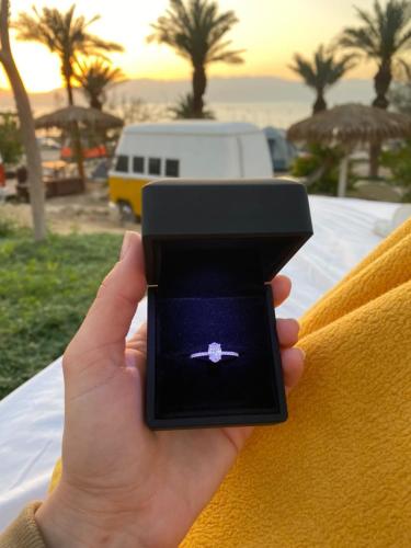 a person holding a cell phone in their hand at Ein Gedi Camp Lodge in Ein Gedi