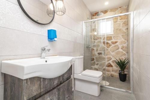 a bathroom with a sink and a toilet and a shower at Villa Maria in Laganas