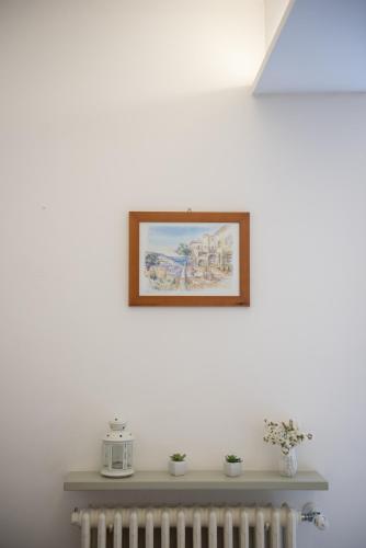 a picture hanging on a wall above a radiator at Al San Lorenzo in Bergamo