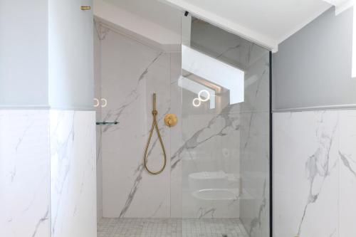a white bathroom with a shower and a toilet at PRESTIGE BOUTIQUE APARTHOTEL - Piazza Duomo View in Milan