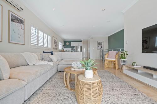 a living room with a couch and a table at The Haven on Blue Bay in Mandurah