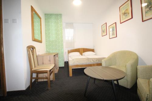 a hospital room with a bed and a table and chairs at Pansion Stari Grad in Sarajevo