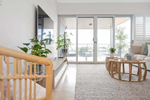 a living room with a table and a couch at The Haven on Blue Bay in Mandurah