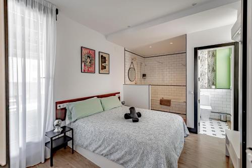 a bedroom with a bed with a teddy bear on it at Ático Centro de Madrid in Madrid