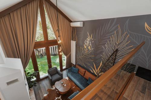 a living room with a couch and a staircase at Toplik Village Resort in Lukavica