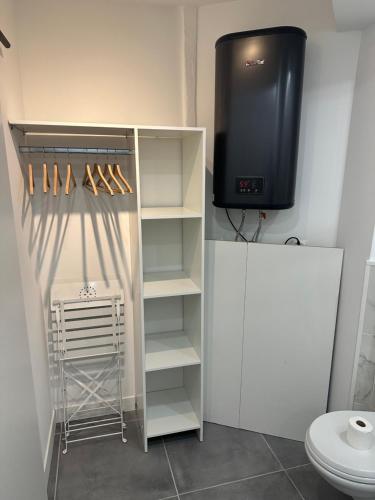 a bathroom with a tv and a closet with shoes at Apart Nissa Bella Seafont / Promenade des Anglais in Nice