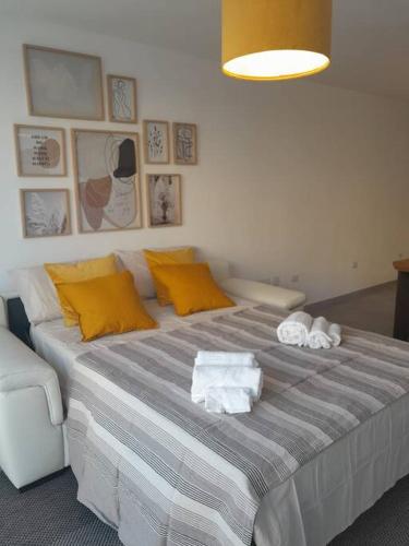 a bedroom with a large bed with towels on it at Elegante monolocale Elmas Cagliari in Elmas