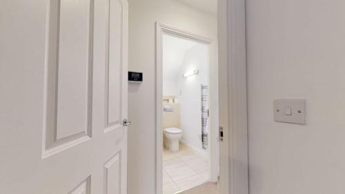a hallway with a door leading to a bathroom at Carriage Crescent in Witney