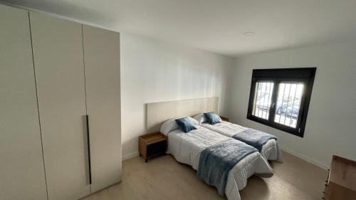 a bedroom with a bed and a window at Txoko Loft Moncayo in Tudela