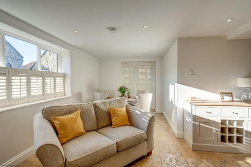 a living room with a couch and a table at Friday Cottage in Wheatley
