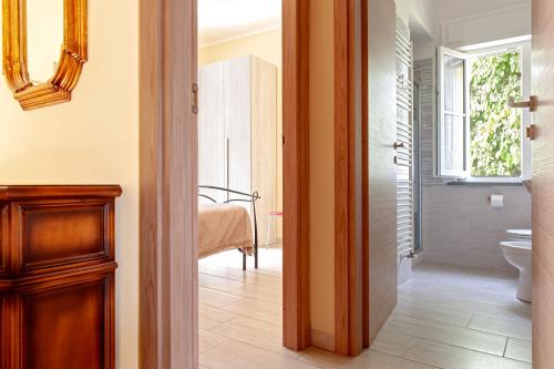 a hallway with a bathroom with a toilet and a window at Antica Fattoria Borghesi in Fauglia