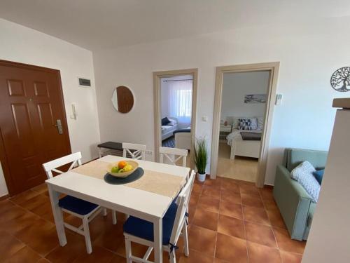 a kitchen and dining room with a table and chairs at MP More in Srima