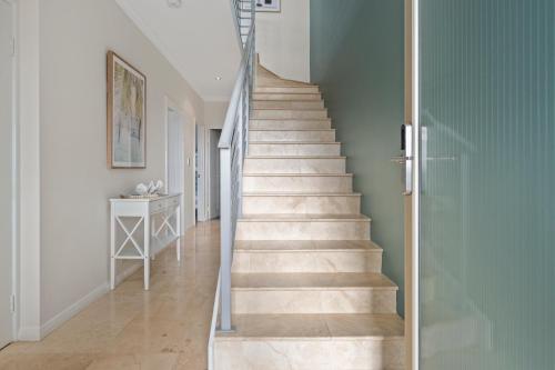 a staircase in a house with a glass door at The Haven on Blue Bay in Mandurah