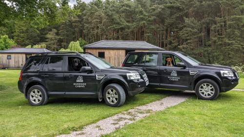 two black trucks parked next to each other at Riverside Cabins in Shrewsbury