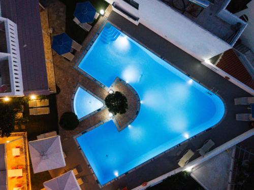 an overhead view of a swimming pool at night at Myrtis Spa Hotel in Plakias