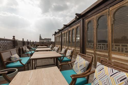 a row of tables and chairs on a balcony at Le Riad Hotel de Charme in Cairo