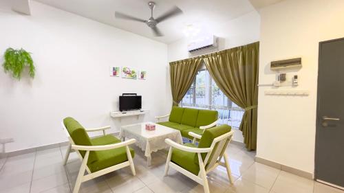 a waiting room with green chairs and a table at De Qasturee KLIA@Kota Warisan homestay nearest to airport in Kampong Besut