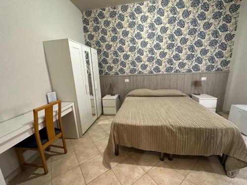 a bedroom with a bed and a dresser and a desk at Hotel Città Studi in Milan