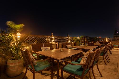 a row of tables and chairs on a patio at night at Le Riad Hotel de Charme in Cairo