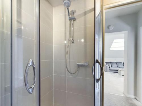 a bathroom with a shower with a glass door at The Hideout King Bed/w TV Free Parking in Cheltenham