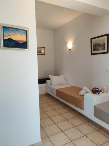 a bedroom with two beds and a tile floor at The Fig Tree - Deluxe Studio in Ios Chora