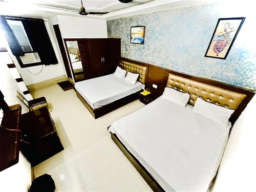 a hotel room with two beds in a room at Blossom residency By Dolphin 500 Mtr Taj mahal in Agra