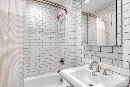 a white bathroom with a sink and a mirror at East Village 1br w wd nr First Park NYC-1035 in New York