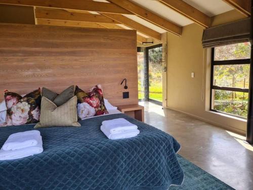 ein Schlafzimmer mit einem großen Bett mit zwei Handtüchern darauf in der Unterkunft Stone Cottage in Dullstroom