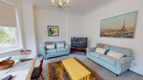 a living room with two couches and a tv at The Bardwell in Oxford