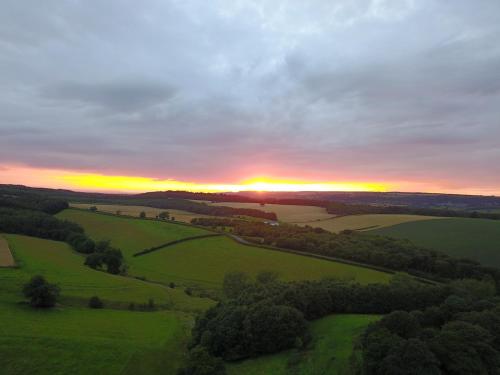 an aerial view of a sunset over a green field at Gilling Gap in York