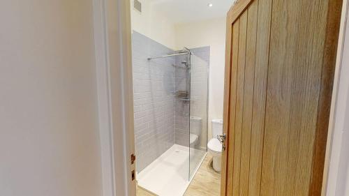 a bathroom with a shower and a toilet at Texel Barn in Witney