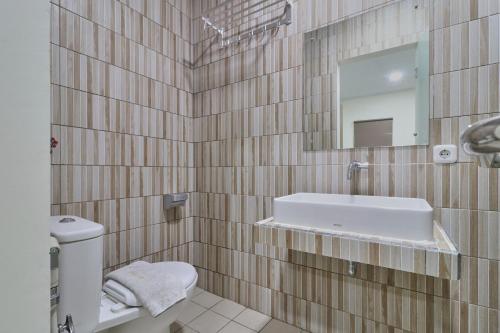 a bathroom with a sink and a mirror at Aranis Hotel in Jakarta