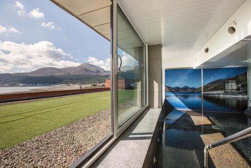 a house with a view of the water and mountains at Slieve Donard in Newcastle