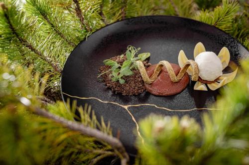 a black plate with some plants on a christmas tree at Caravan Park Sexten in Sesto