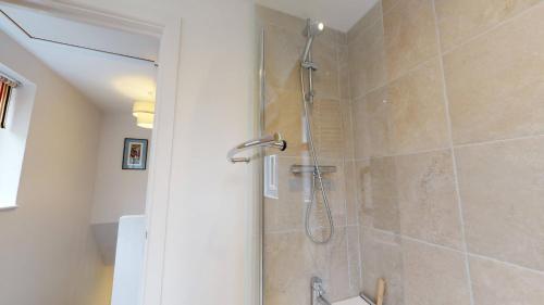 a bathroom with a shower with a glass door at Park View in Oxford