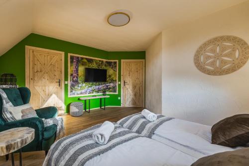 a bedroom with a bed and a green wall at Willa Skała in Kościelisko