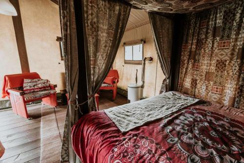 a bedroom with a bed in a room with curtains at Kampari in Delfstrahuizen
