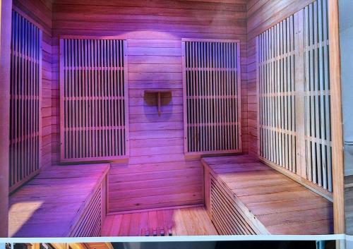 a wooden sauna with wooden benches in a room at Wellness Loft Huy in Huy
