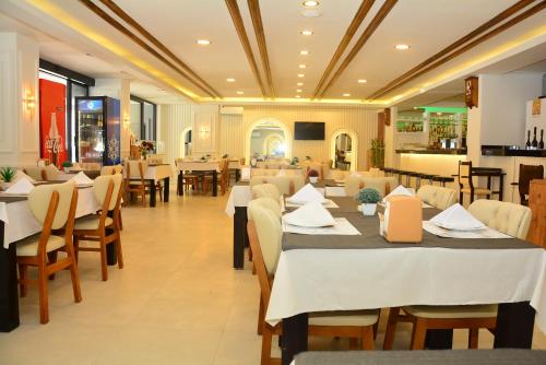 un comedor con mesas y sillas en un restaurante en Rafael Hotel en Manavgat