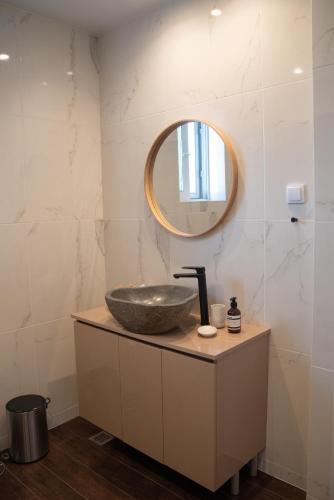 a bathroom with a sink and a mirror at Naiads Nest - The Comfort Lux in Varkiza