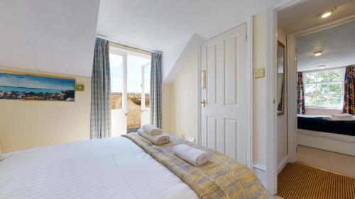 a bedroom with a large bed with towels on it at Portland Street Apartment in Leamington Spa
