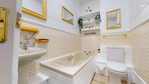 a white bathroom with a sink and a toilet at Portland Street Apartment in Leamington Spa