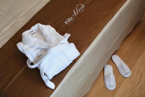 a white robe and a pair of shoes in a box at Agriturismo Villa Almè in Oderzo