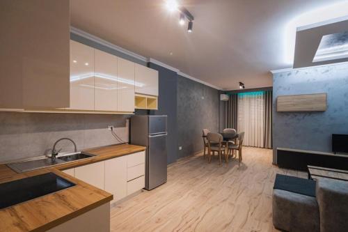 a kitchen and living room with a table and chairs at Holiday Apartment in Vlorë