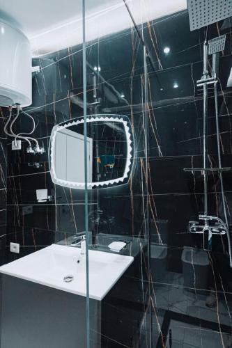a bathroom with a sink and a mirror at Holiday Apartment in Vlorë