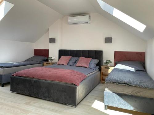 a bedroom with two beds in a attic at Apartamenty przy Parku -150m od plaży in Darłówko