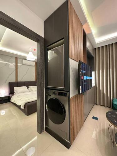 a room with a bed and a washing machine in it at modern apartment in abdoun-amman in Amman
