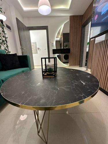 a marble table in a living room with a chair at modern apartment in abdoun-amman in Amman