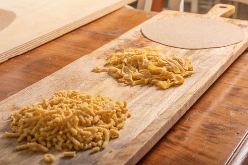 a wooden cutting board with some food on it at Hotel Villa Maris in Rimini